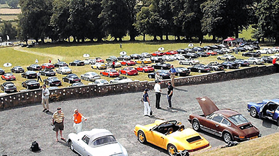 Concours cars in the foreground and photo trail cars on the grass beyond at the Celtic Manor Hotel, the lunchtime stop-over for the Photo Rally
